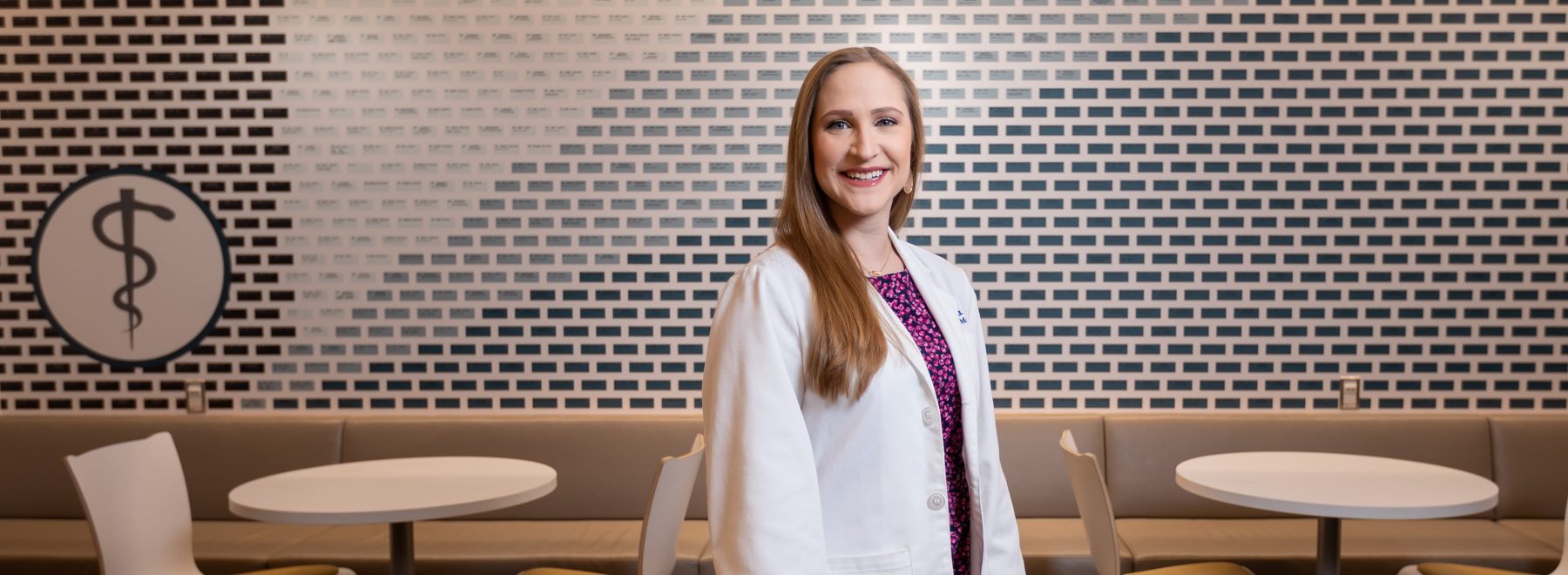 Female MD/PhD student poses in medical student lounge.